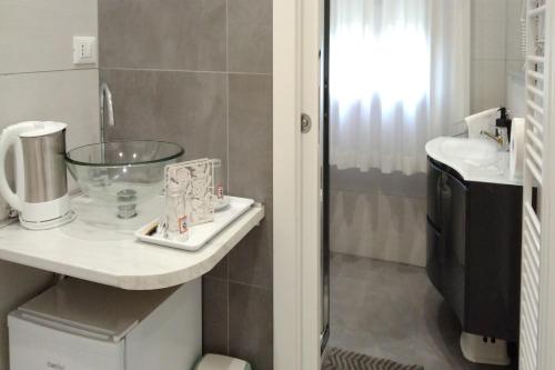 a bathroom with a sink and a glass bowl on a counter at GreenColors DEPENDANCE in Campalto
