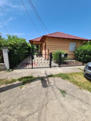 a house with a gate in front of it at Zseki apartman in Hajdúszoboszló