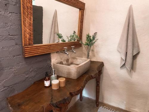 a bathroom with a concrete sink and a mirror at Lush in Graskop