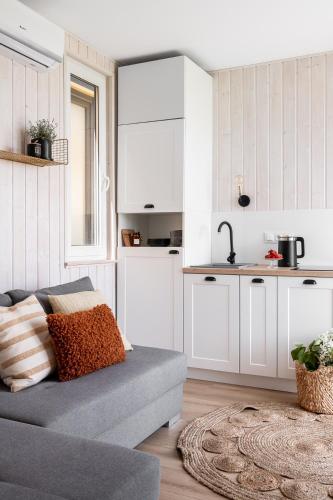 a living room with a couch and a kitchen at ZATORHOUSE in Zator