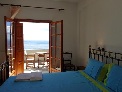 a bedroom with a bed and a window at Faros in Milopotamos
