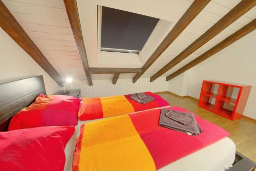 a large bed with a colorful blanket in a room at HITrental Oerlikon Apartments in Zürich