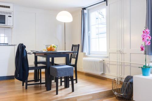 a kitchen and dining room with a table and chairs at HITrental Zeughausgasse - Apartment in Zug