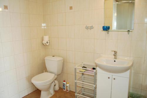 a bathroom with a toilet and a sink at Villa AS in Świnoujście