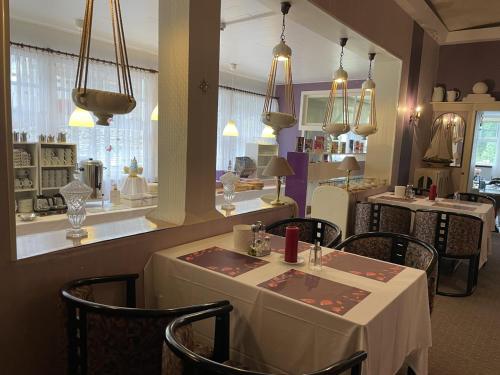 ein Esszimmer mit einem Tisch und Stühlen sowie eine Küche in der Unterkunft Astoria Hotel Bad Wildstein in Traben-Trarbach