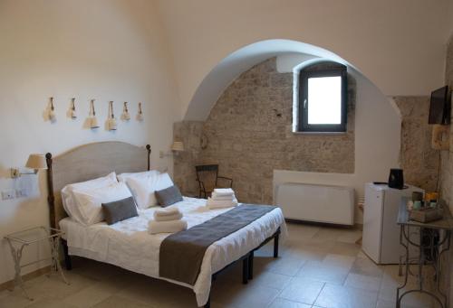 a bedroom with a bed in a room with a window at asfodelo ristorante di campagna in Altamura