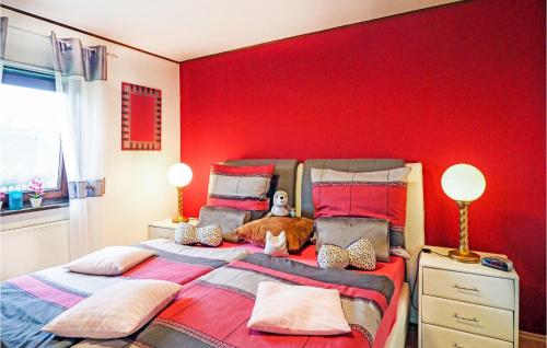 a red bedroom with a dog laying on a bed at Ferienhaus 1 In Thalfang in Thalfang