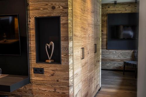 a room with a wooden wall with a heart on it at DAS Hintersee in Hintersee
