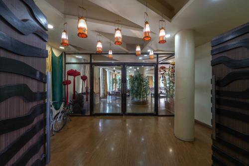 an empty hallway with a lobby with glass doors at Triose Boutique Hotel Lonavala in Lonavala