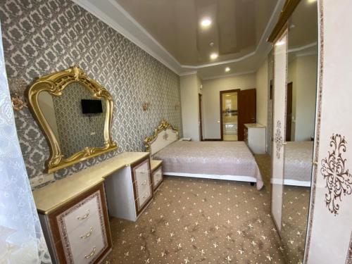 a bedroom with a bed and a large mirror at VitaPark Stariy Dub in Truskavets