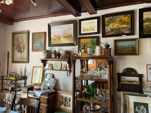 a room with a bunch of paintings on the wall at Birnbom Warnemünde in Warnemünde