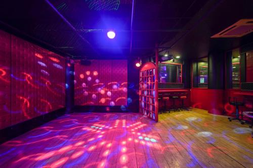 a room with a dance floor with purple lights at Triose Boutique Hotel Lonavala in Lonavala