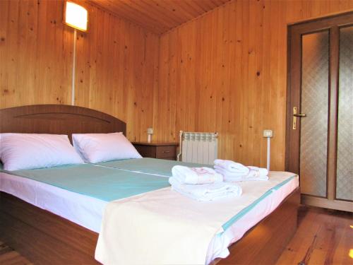 a bedroom with a bed with towels on it at Arpa Valley Cabin in Yeghegnadzor