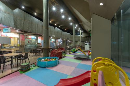 a childrens play area with a slide and a playground at Triose Boutique Hotel Lonavala in Lonavala