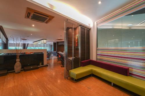 a living room with a couch and a table at Triose Boutique Hotel Lonavala in Lonavala