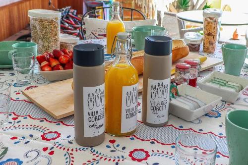 a table topped with bottles of orange juice and bread at Villa dos Corcéis in Esposende