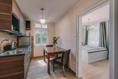 a small kitchen with a table and a bed at Bringa Villa in Balatonlelle