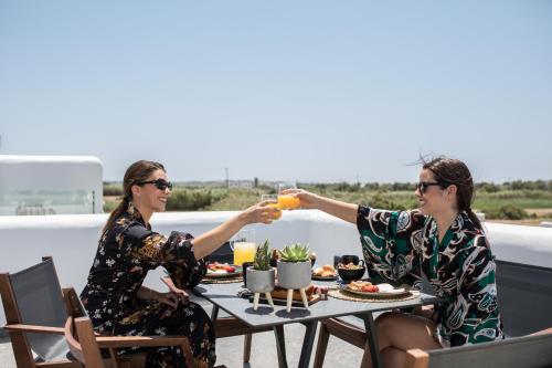 two women sitting at a table with drinks at Naxian Secret in Naxos Chora