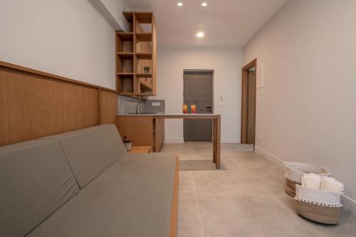 a living room with a couch and a table at Paradise Elegant Apartments - Perfect escape on the beach in Alykes