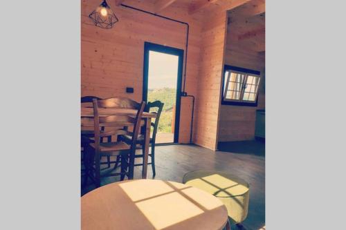 a dining room with a table and some chairs at Eco Lodge nella natura Con Piscina privata "La Grande Quercia" in Calangianus