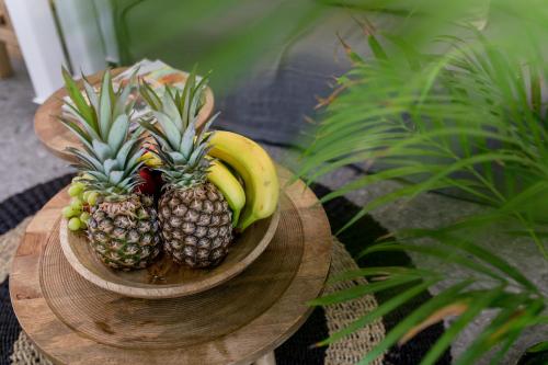 two pineapples and bananas on a wooden table at Naxian Secret in Naxos Chora
