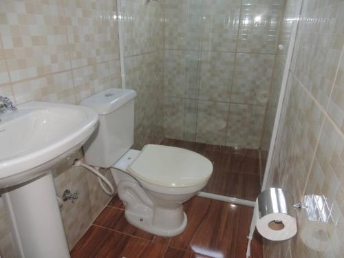 ein Bad mit einem WC, einem Waschbecken und einer Dusche in der Unterkunft Suíte 5 com wifi a 4 min da praia em Caraguatatuba in Caraguatatuba