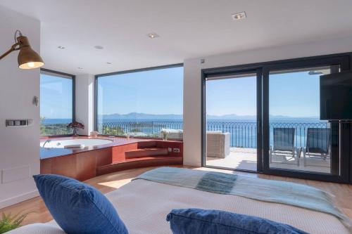 a living room with a view of the ocean at Ca Na Bruixa,con piscina y vista al mar in Alcanada