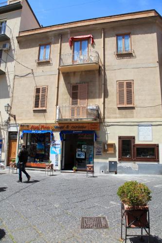 a man walking past a building in a street at Garibaldi B&B in Cefalù