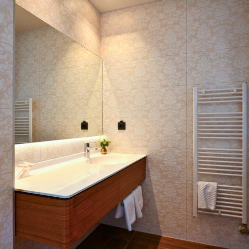 a bathroom with a sink and a mirror at Heritage Hotel Krone in Sarajevo