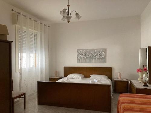 a bedroom with a large bed in a room at Buganville in Torre Lapillo