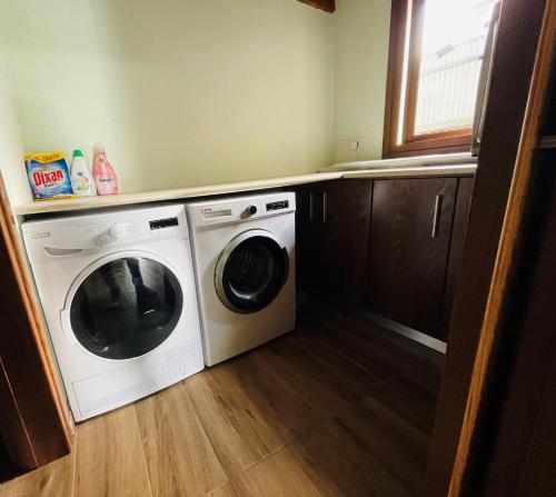 a washer and dryer in a small room at Lovely house not far from the beach, near Protaras in Dherinia