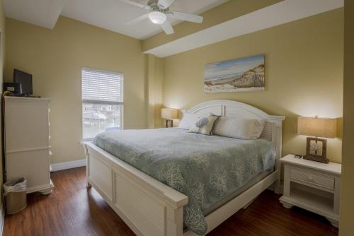 a bedroom with a bed and a ceiling fan at Madeira Bay Heated Pool 204 Star5Vacations in St Pete Beach