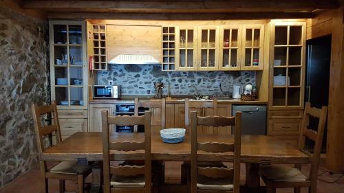 a kitchen with a wooden table and chairs at Casa da Cortiça in Figueiró dos Vinhos