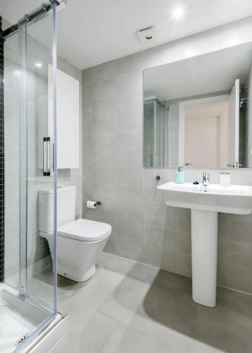 a bathroom with a toilet and a sink and a shower at Casa Lobo Panticosa in Panticosa