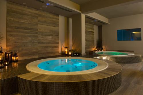 two hot tubs in a hotel room with two at Hotel Casali in Cesena