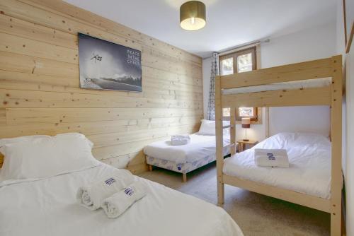 1 dormitorio con 2 camas y 1 litera en Beziere - Snow and Trek, en Morzine