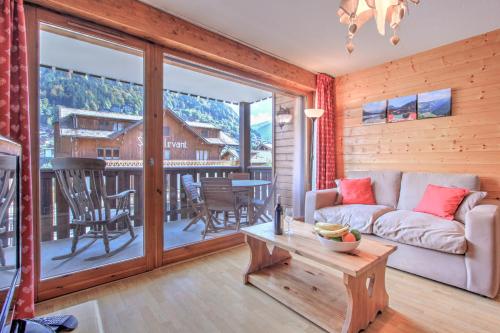 a living room with a couch and a table at Slalom Apartment - Very Town Centre - Snow and Trek - Morzine in Morzine