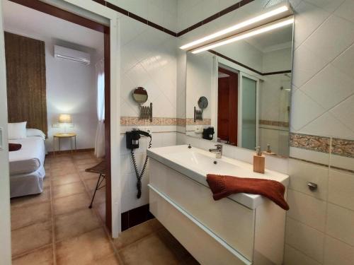 a bathroom with a sink and a large mirror at Villa 21 in Puerto del Carmen