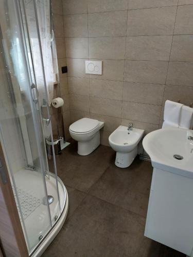 a bathroom with a shower and a toilet and a sink at Bed&Breakfast Luna in San Salvo