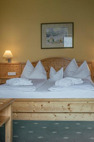 a bed with white pillows on top of it at DAS Hintersee in Hintersee