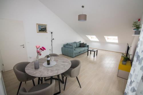 a living room with a table and chairs and a couch at Apartment Skylight in Kostrena