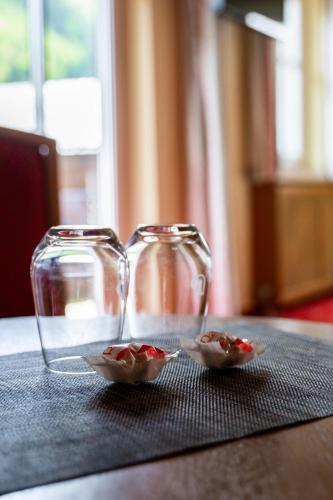 two glass containers sitting on top of a table at DAS Hintersee in Hintersee