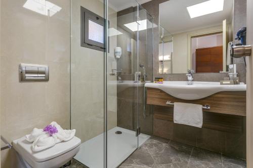 a bathroom with a toilet and a sink and a shower at Porto Platanias - Casa Di Porto in Plataniás