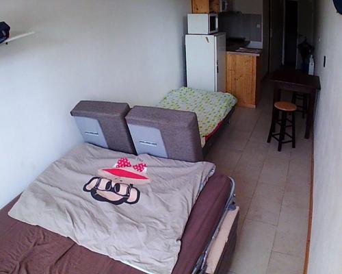 um pequeno quarto com duas camas e uma mesa em studios em Belfort