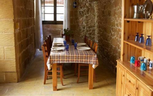 a table in a kitchen with a table cloth on it at Ta' Salvu u Marija in Munxar