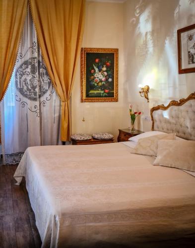 a bedroom with a large bed and a window at B&B Joan's Heritage in Taormina