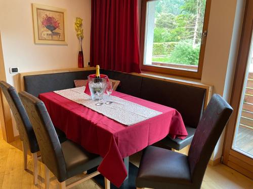 a dining room table with a red table cloth on it at Villa Anita San Vigilio di Marebbe in San Vigilio Di Marebbe
