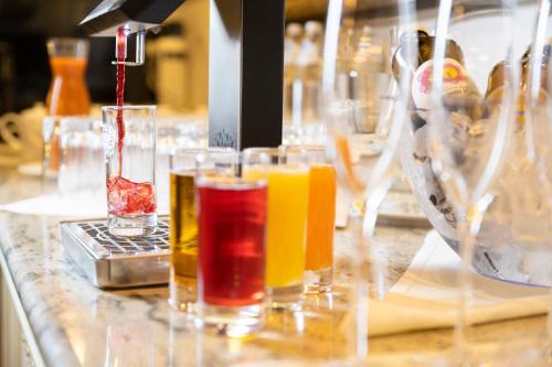 a group of glasses sitting on a counter with juice at EUROPÄISCHER HOF Bad Gastein in Bad Gastein
