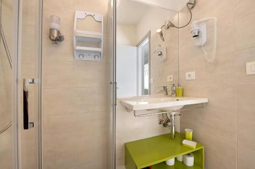 a bathroom with a sink and a shower at Residence La Mignon Terrazza in Torri del Benaco