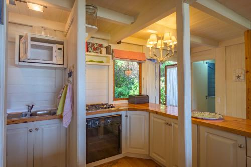 a kitchen with a sink and a microwave at Windhoek on Sea in Eersterivierstrand